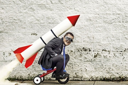 Man sitting on rocket-propelled tricycle