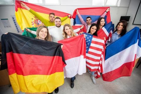 International students holding up flags of their home countries