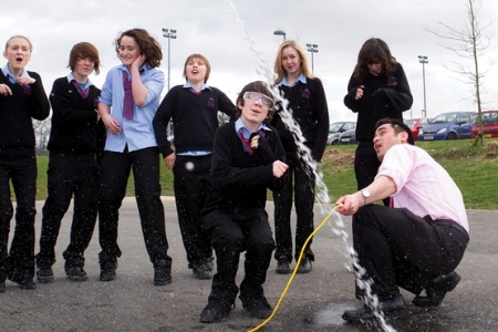 Teacher and pupils launching a bottle rocket