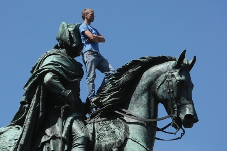 German student standing on statue