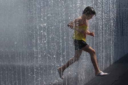 Child running through fountain