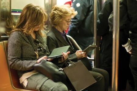 Women reading ebooks on New York subway