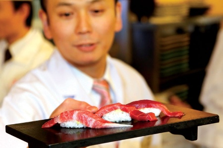Japanese man serving sushi