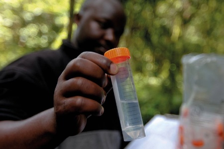 Rwandan man holding vial