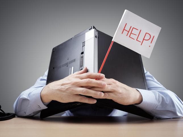 Man with a laptop computer over his head and a Help! sign