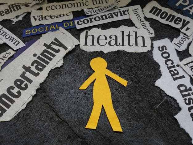 Yellow paper figure surrounded by headlines about health and money anxieties, Covid uncertainty