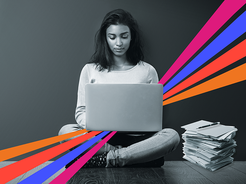 Young female academic writing on laptop illustrating spotlight on academic writing