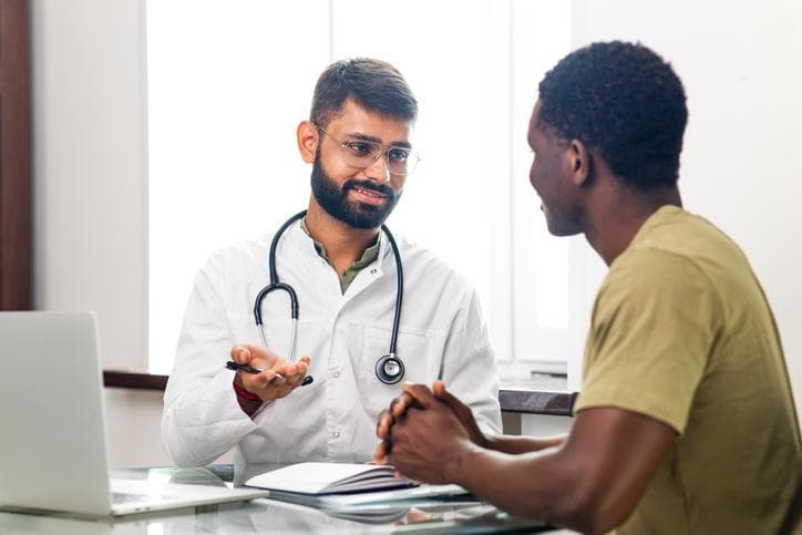 Young doctor talking to a Black patient