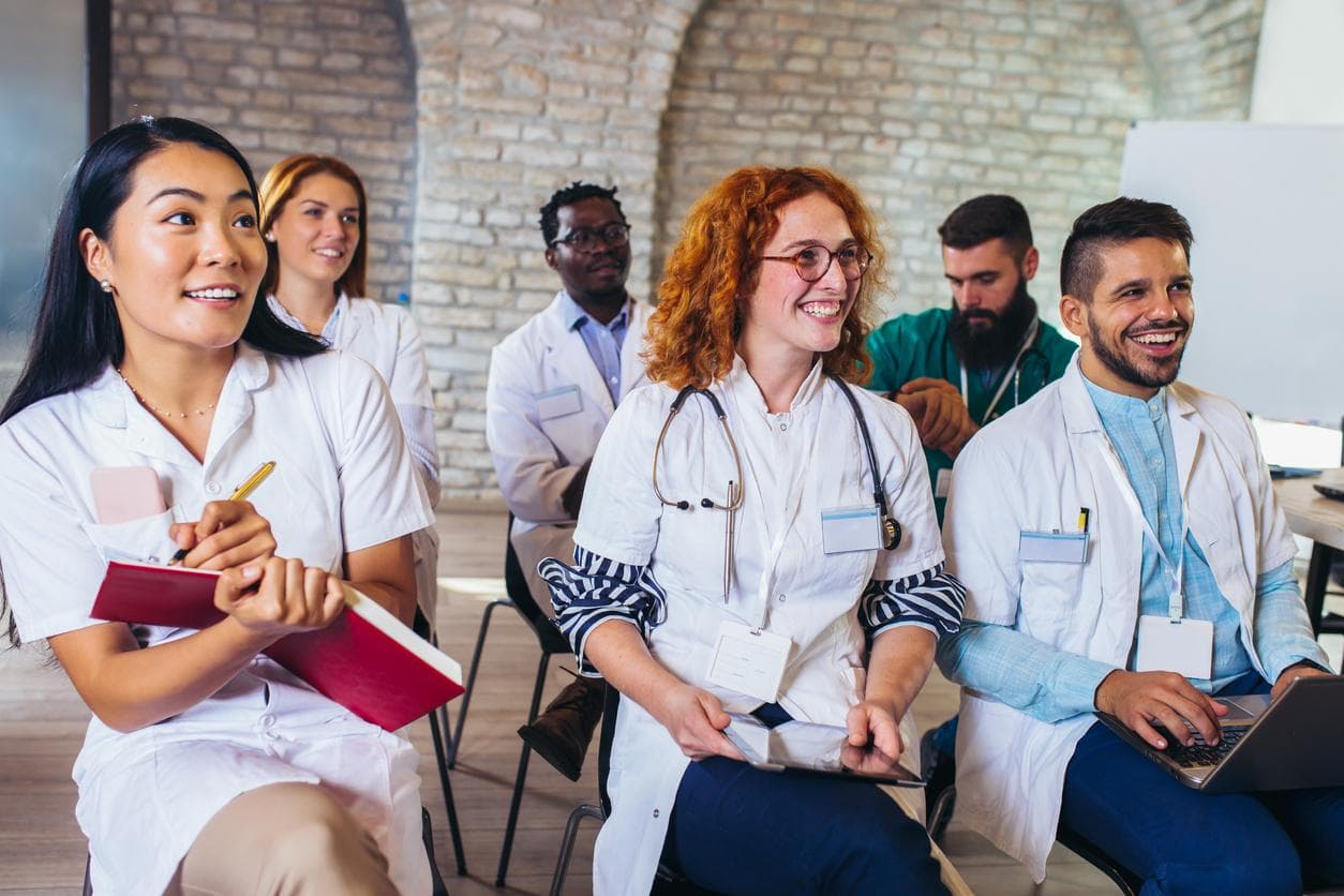 A diverse group of medics sitting through a seminar