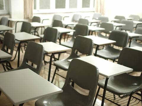 Empty desks and chairs in classroom illustrating classroom design