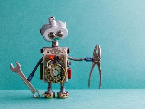 A robot holding tools to illustrate a resource offering advice for universities on using 'bots'