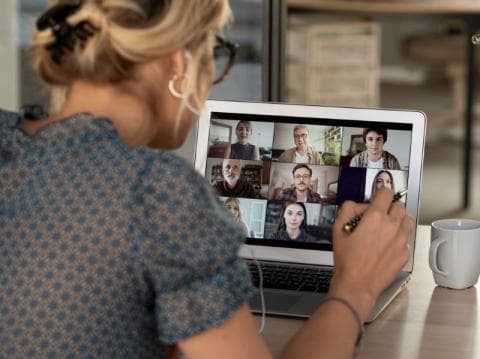 A remote student working in a group with other students via an online meeting