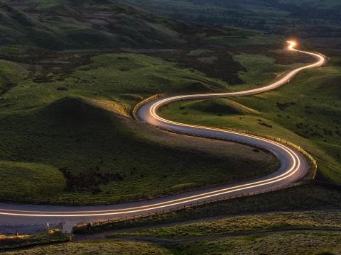 A light guiding the way along a winding road