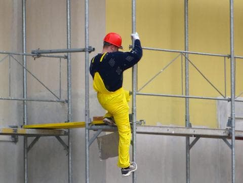 Man climbs scaffolding