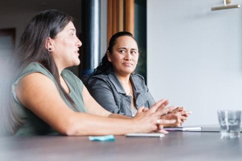 Two Maori women talking in an office
