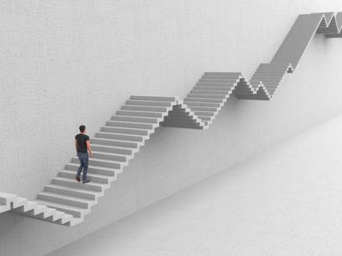 Man climbing up-and-down graph-like staircase