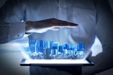 A holographic image of urban development emerging from the tablet