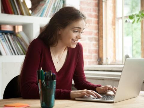 young smiling woman using laptop