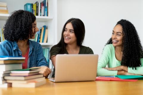 Three latina students studying together
