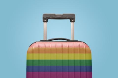 A suitcase decorated in rainbow stripes