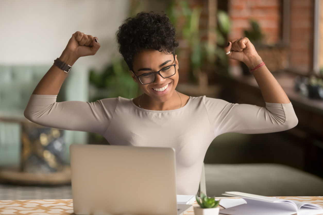 Student at laptop, cheering