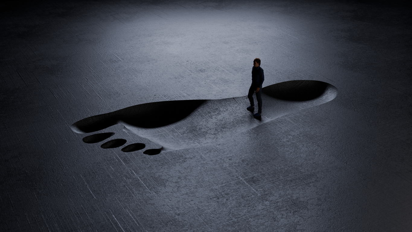 Man standing in giant footprint