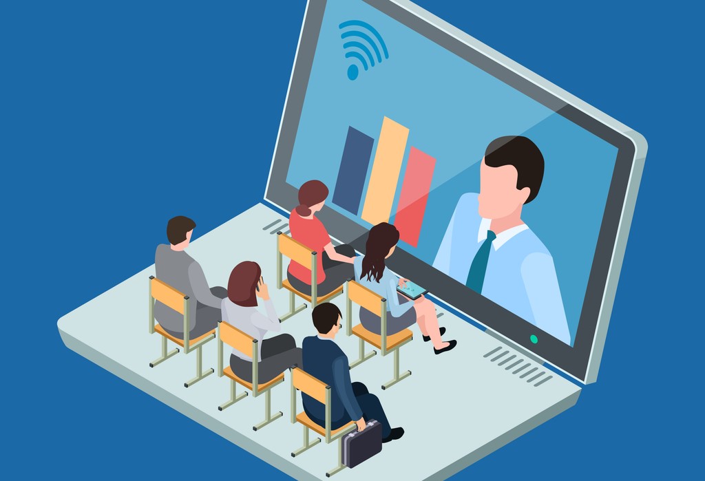 Students sitting at desks on a computer keyboard