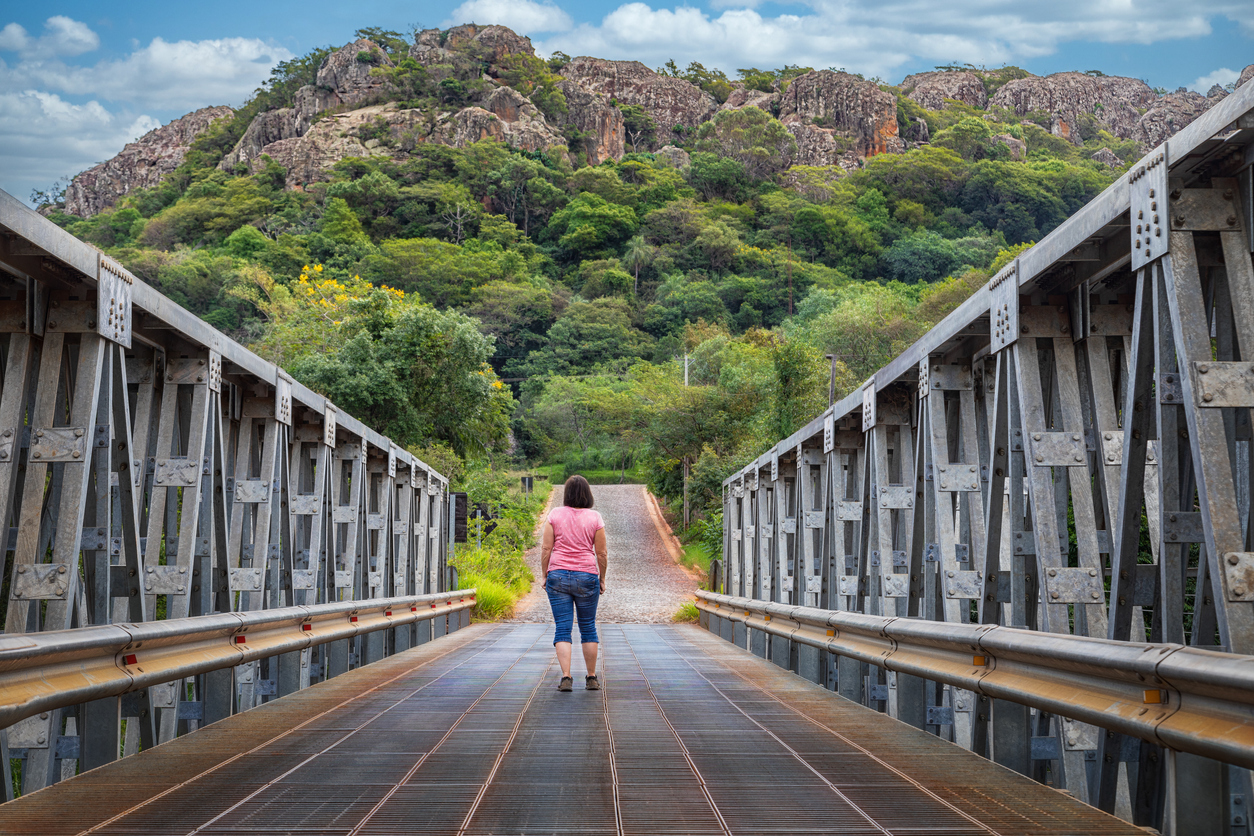 Woman walking across the metal bridge of Tobati, Paraguay