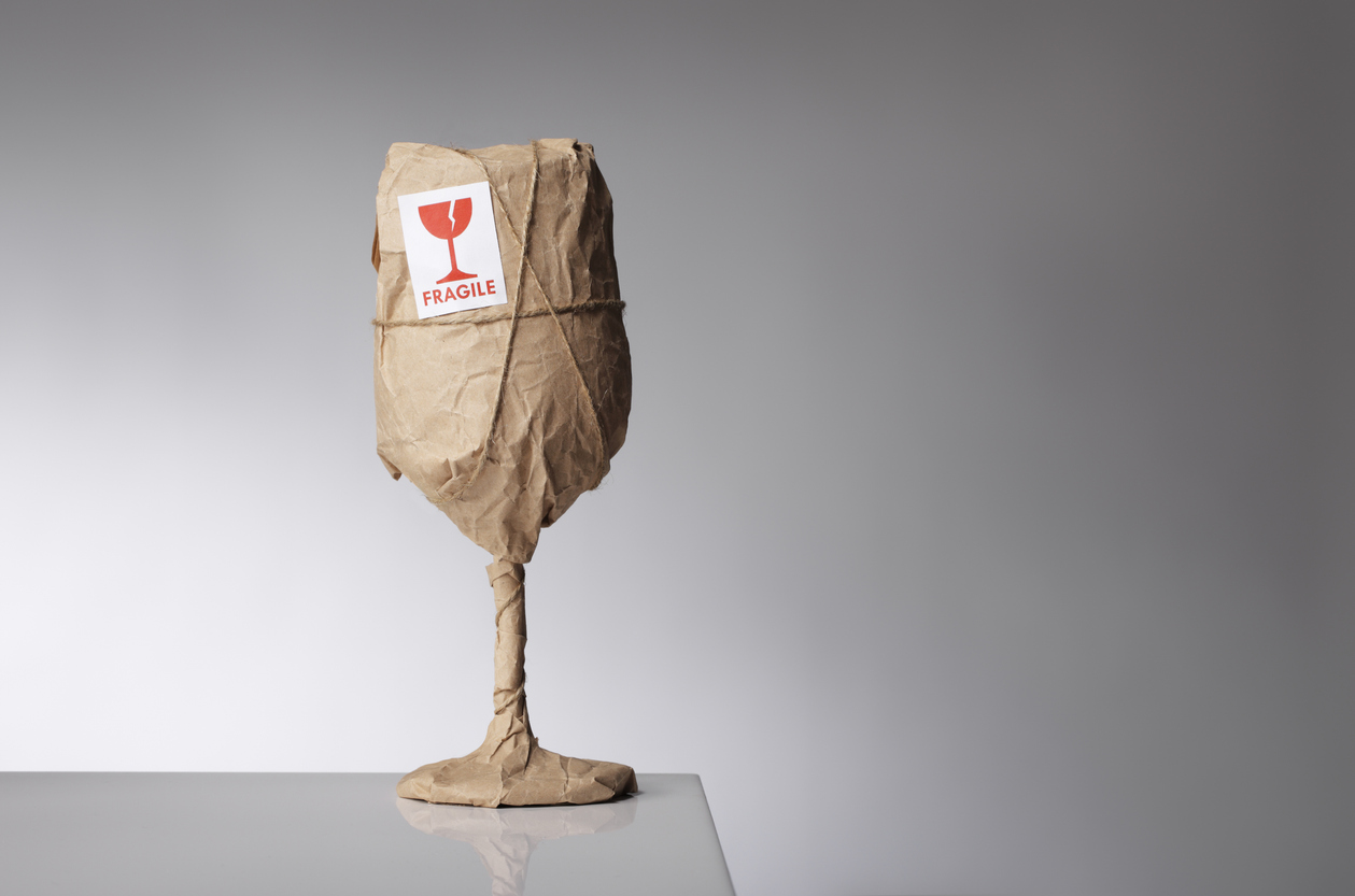 Glass wrapped in brown paper, labelled "Fragile"