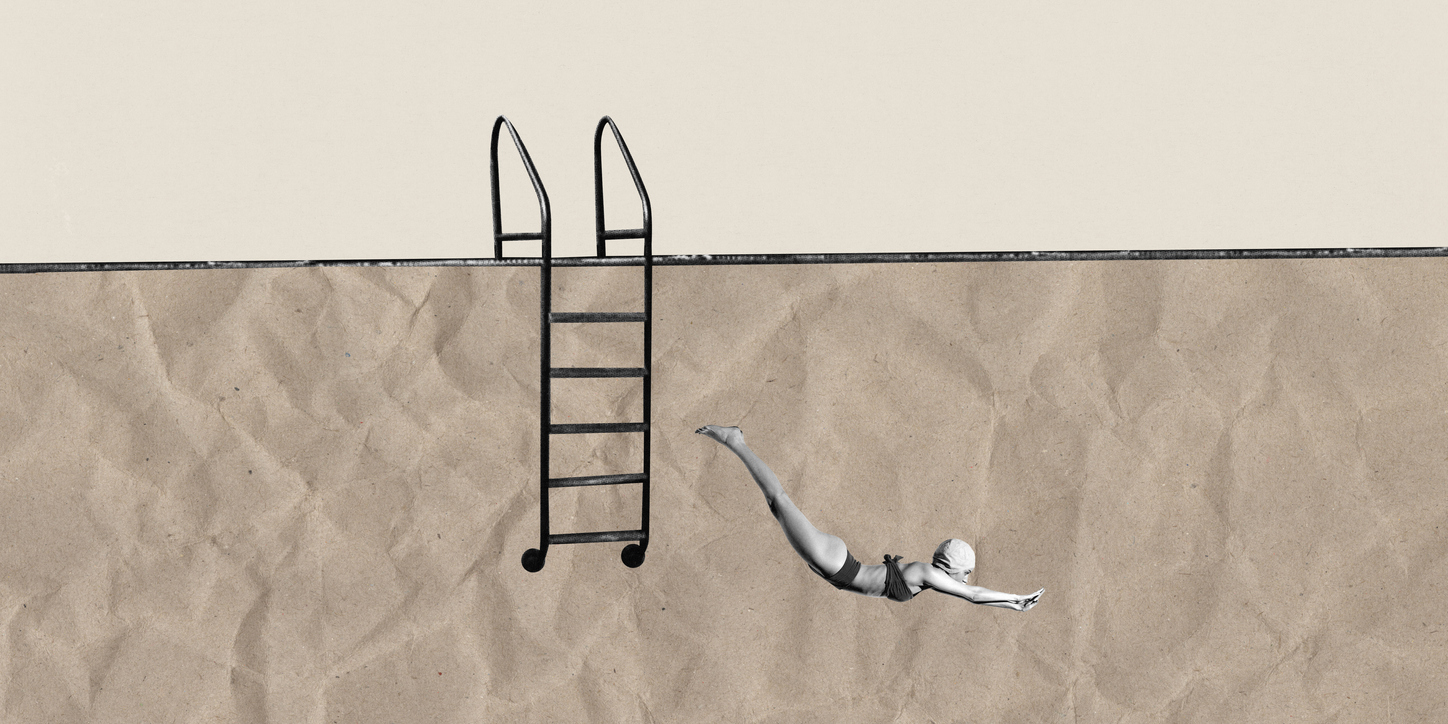 Woman diving into deep end of swimming pool