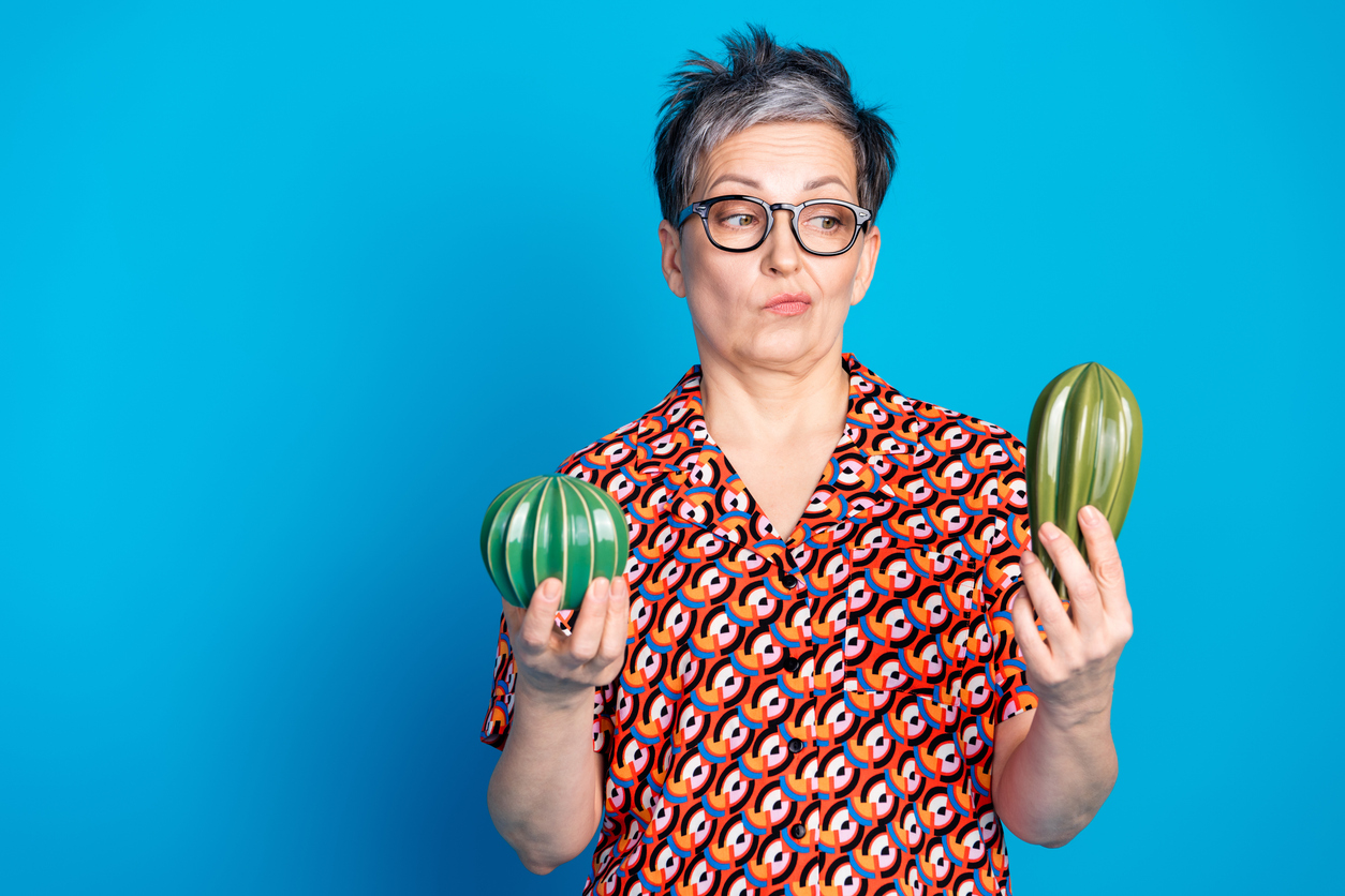 A woman choosing between two similar - but slightly different - objects