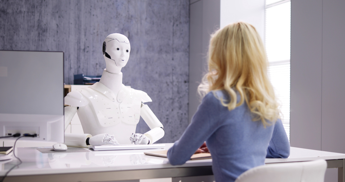Student at desk, being interviewed by a robot