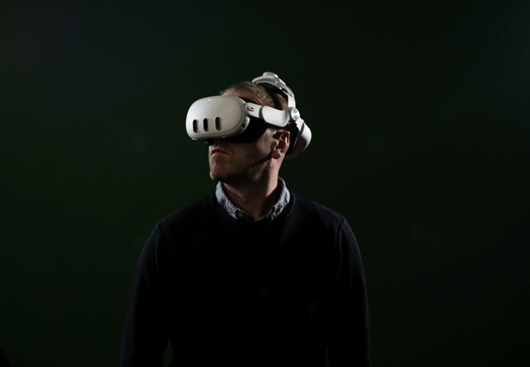 Man wearing a VR headset in a dark room
