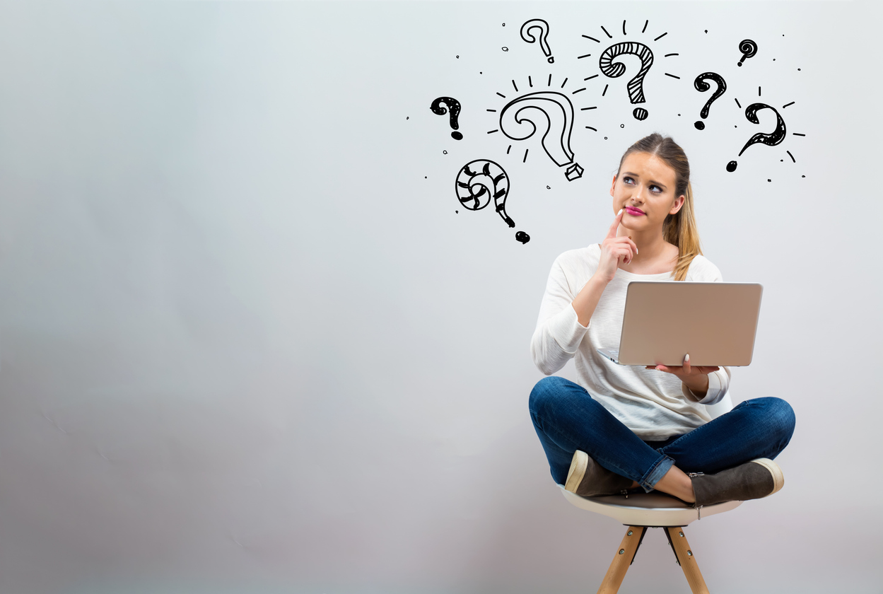 Student sitting with laptop, with line-drawing question marks around her head