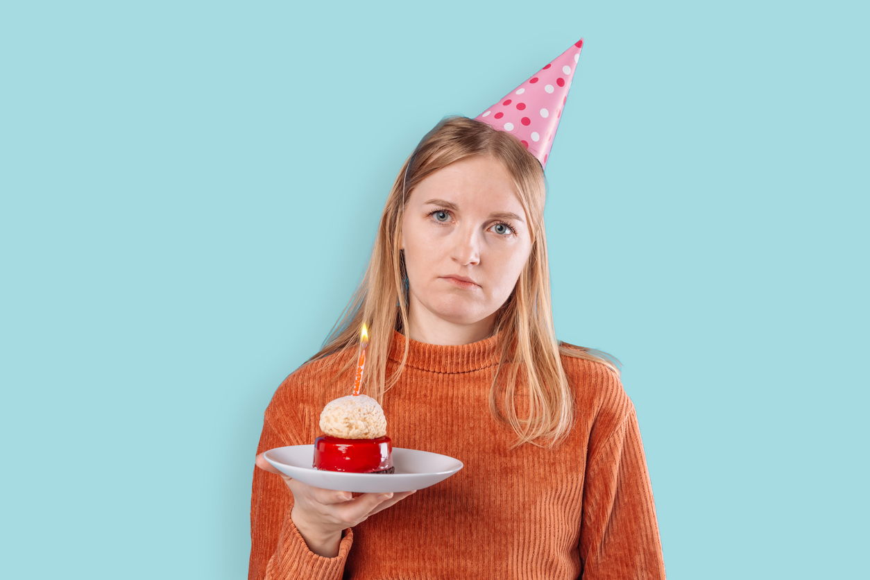 Woman looking miserable at birthday party