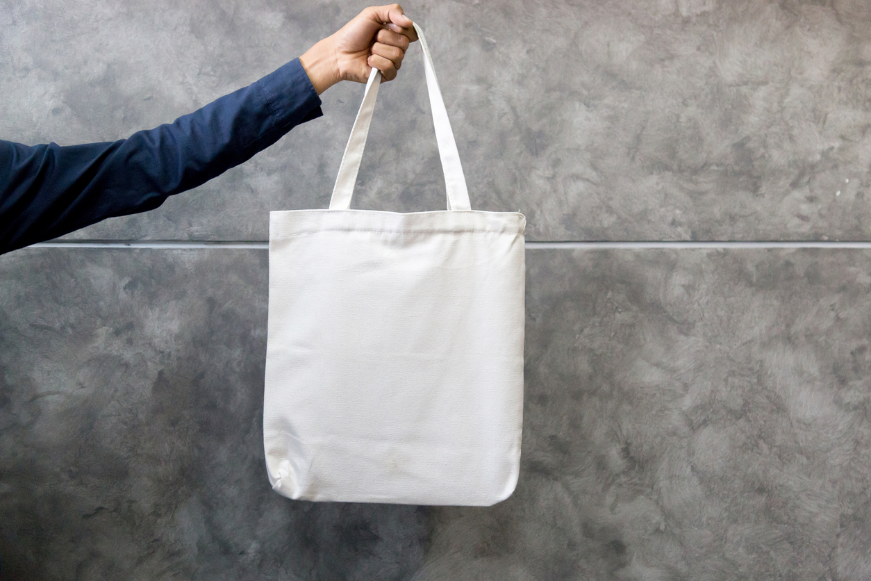 Hand holding tote bag