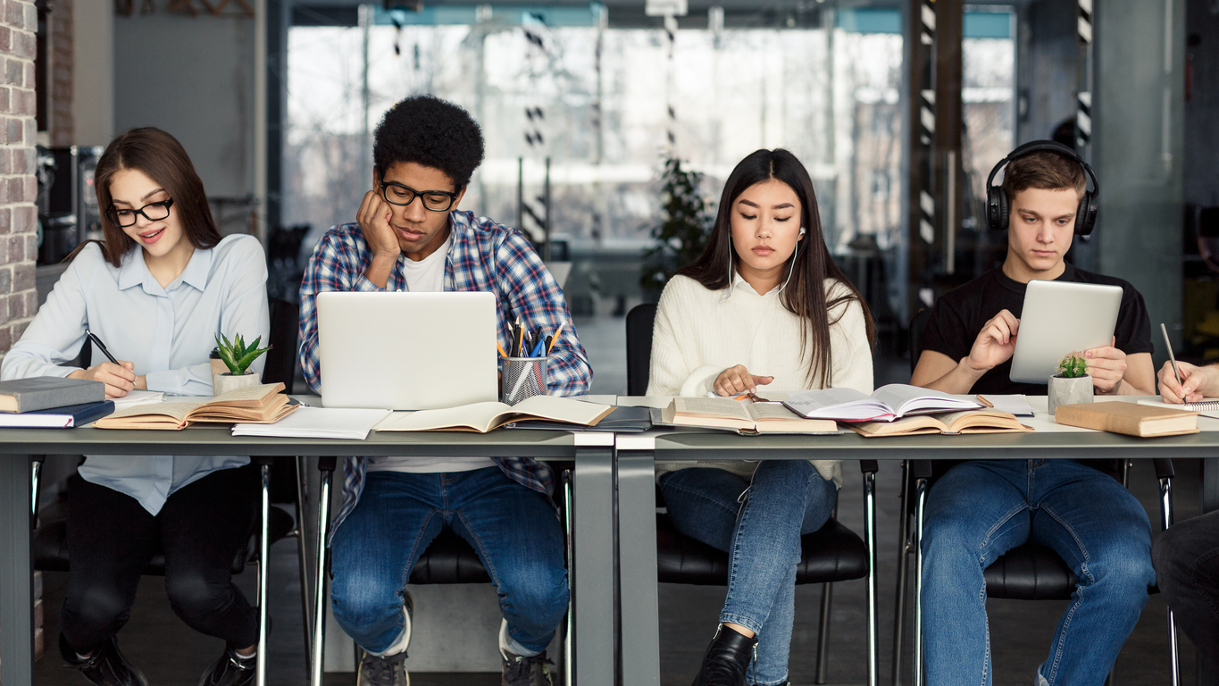 Four students, working on university applications