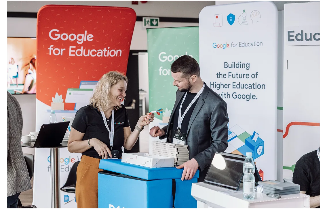 Delegates talking at a Google for Education exhibition stand at a higher education event