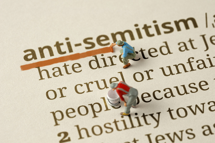 Workers underlines the word "Antisemitism" in the dictionary