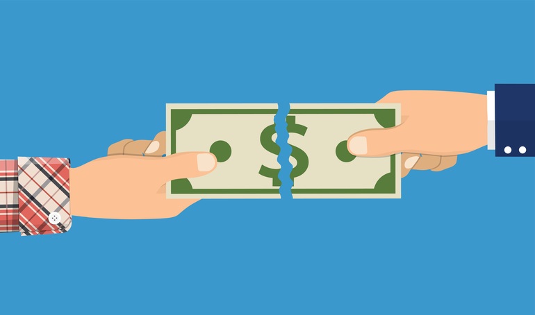 A dollar bill being torn