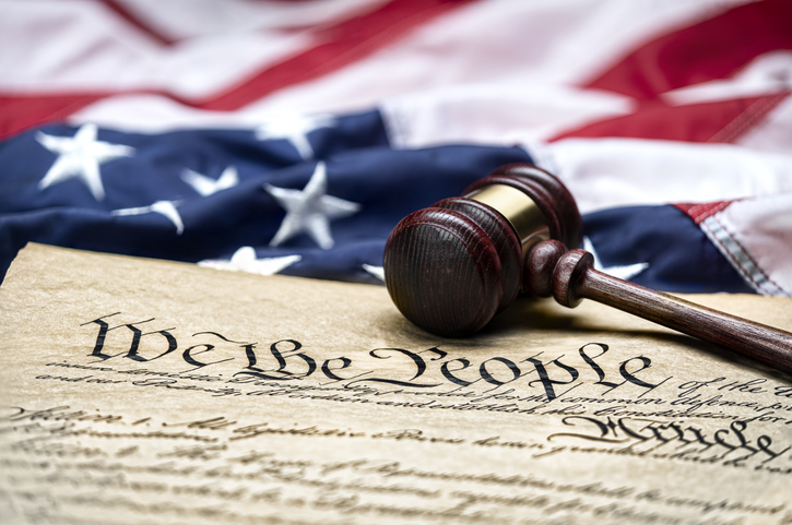 The US constitution, with a gavel next to it