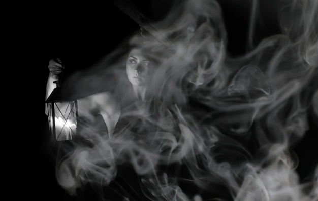 A woman with a gas light