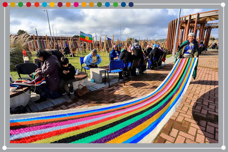 Indigenous Mapuche women weave on a loom a 1-kilomemter weave in an attempt to break a Guinness Record in Puerto Saavedra, Chile on 21 May 2022. To illustrate how universities can learn from the sustainable use of textiles in South America.