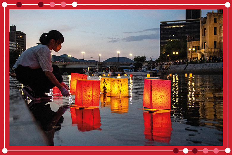 People release paper lanterns on the Motoyasu River beside the Hiroshima Prefectural Industrial Promotion Hall, commonly known as the atomic bomb dome, to mark the 77th anniversary of the world’s first atomic bomb attack in Hiroshima on 6 August 2022.