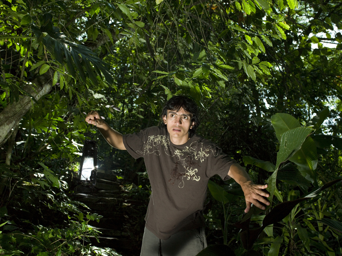 A man looking fearful in the jungle, illustrating visceral fear