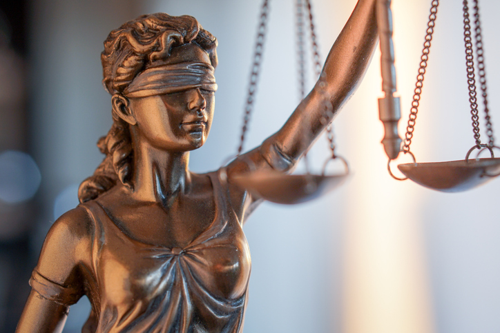 A statue of justice illustrating opinion article about double-blind peer review