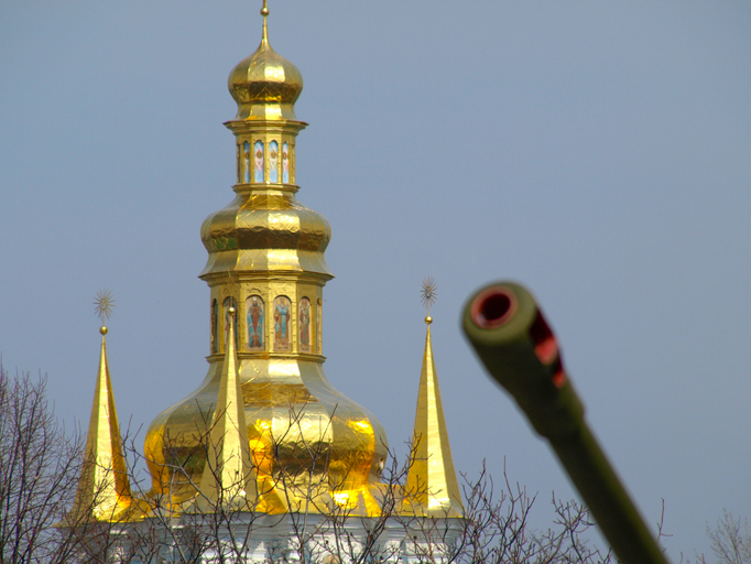 A Kyiv church with a tank gun in the foreground, illustrating the war in Ukraine