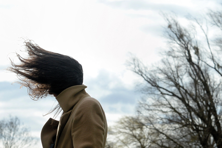 Woman with hair blown by wind