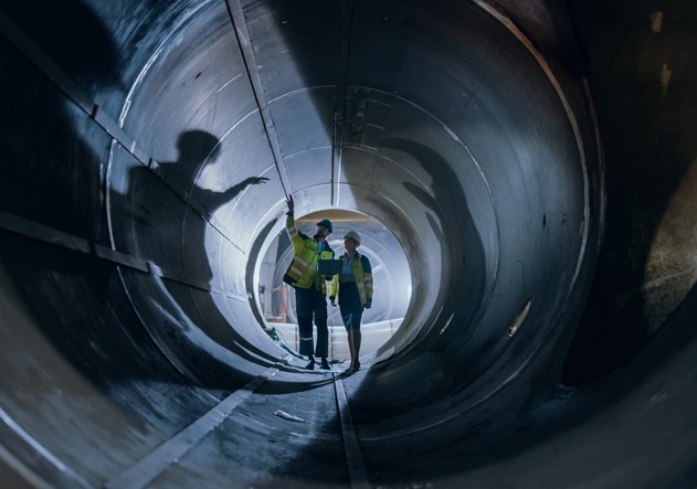 Two engineers walking inside a large pipe, symbolising the skills pipeline