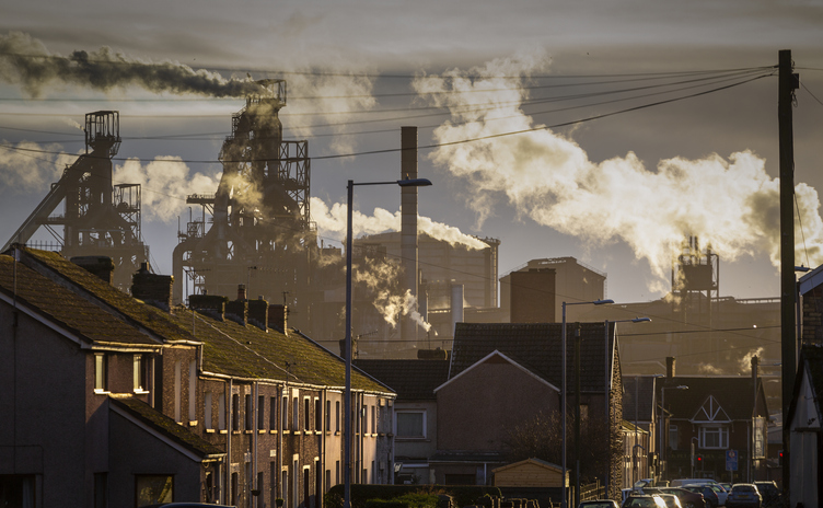 Houses in front of a steelworks in Port Talbot, symbolising local impact